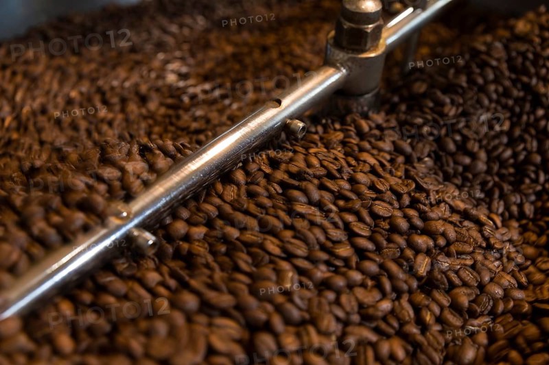 Coffee is roasted by hand in a small drum roaster with lots of experience, where the hot freshly roasted coffee beans cool down using air in a sieve, Kaffeerösterei Müller, Wildenhain, Großenhain, Saxony, Germany