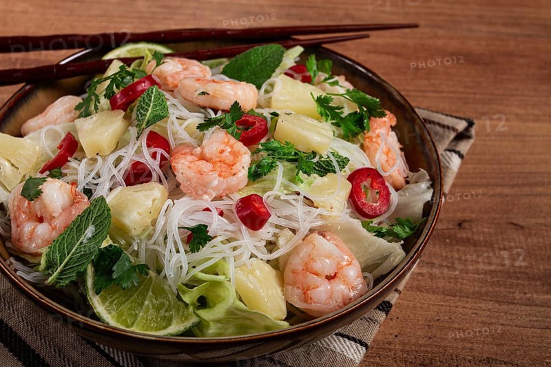 Thai salad with shrimp and rice noodles, pineapple slices, coriander and mint leaves, homemade, no people