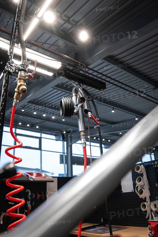 Modern bicycle workshop with hanging air tube and tools, bright industrial lighting, Waldbike Manufaktur, bicycle workshop, Calw, district of Calw, Black Forest, Germany