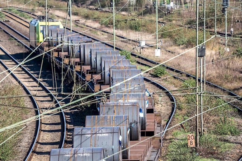 Freight train on the line in front of the Oberhausen-Osterfeld marshalling yard, loaded with steel coils, rolled up strip steel for further processing, from the ThyssenKrupp steel plant in Duisburg, North Rhine-Westphalia, Germany