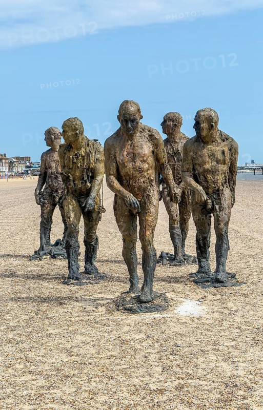 'Walking Men' artwork bronze sculptures by Laurence Edwards, South Beach, Lowestoft, Suffolk, England, UK July 2024