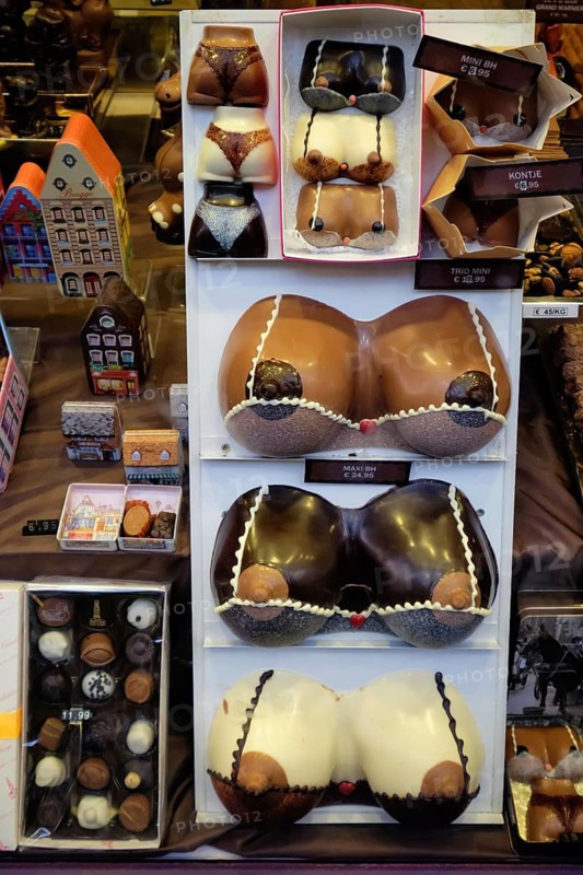 BRUGES, BELGIUM, MAY 28, 2018: Famous belgian black, white and milk chocolates in a Belgian shop showcase