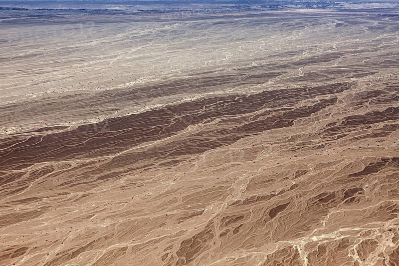 Aerial view of an extensive desert area with distinctive textures and patterns, The landscape and desert near Nasca in the Andes of Peru