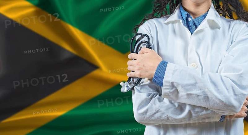 Healthcare professional with Jamaica flag background. Professional doctor holding stethoscope on Jamaica flag background