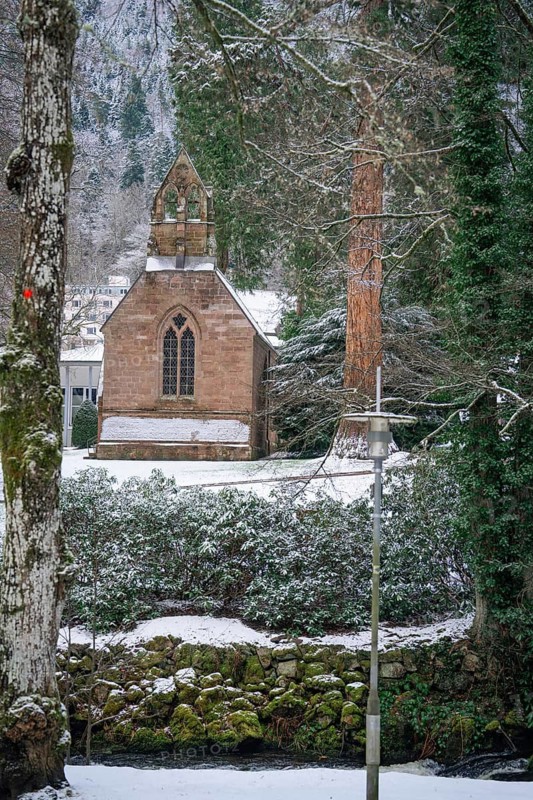 Snowy chapel in the forest, surrounded by trees, with a quiet winter atmosphere, spa garden, English Church, Bad Wildbad, Black Forest, Germany