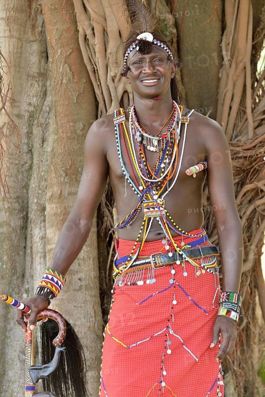 Maasai warrior wearing traditional dress, near Enkutoto, Masai Mara, Rift Valley Province, Kenya