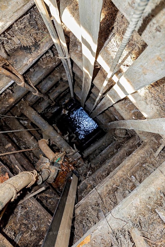 View of a deep wooden well with water at the bottom, the sapphire and gemstone mines at Ratnapura in Sri Lanka