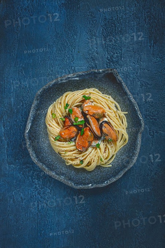 Spaghetti with mussels, without shell, pasta with peeled mussels, in carbonara sauce, micro-greens, homemade, no people