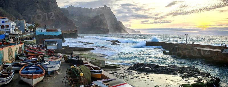 Sunset over a coastal landscape with colorful fishing boats and mountains, romantic harbor scene, graffiti, in dramatic evening light, Ponta do Sol, Santo Antao, Cabo Verde, Cape Verde, Cape Verde, Cape Verde