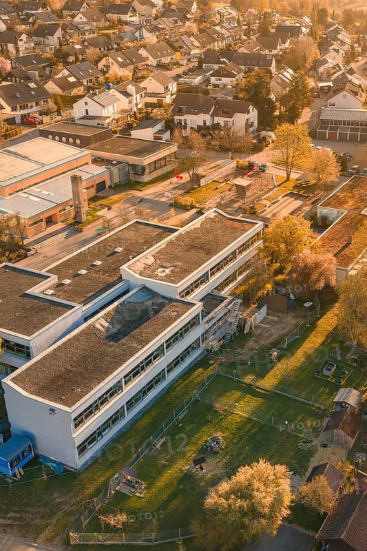 School complex and residential buildings surrounded by autumn gardens and trees, Schlehengäuschule, Gechingen, Hecken and Gäu region, Calw district, Germany