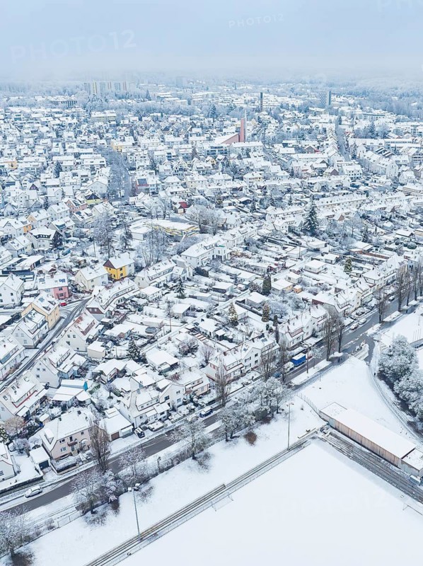 Winter aerial view of a city with snow-covered roofs and streets, Sindelfingen, Germany