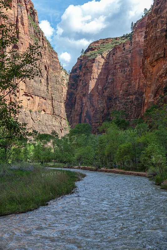Virgin River runs between sandstone rock formations along the Riverside Walk in the Temple of Sinawava area of Zion National Park, Utah