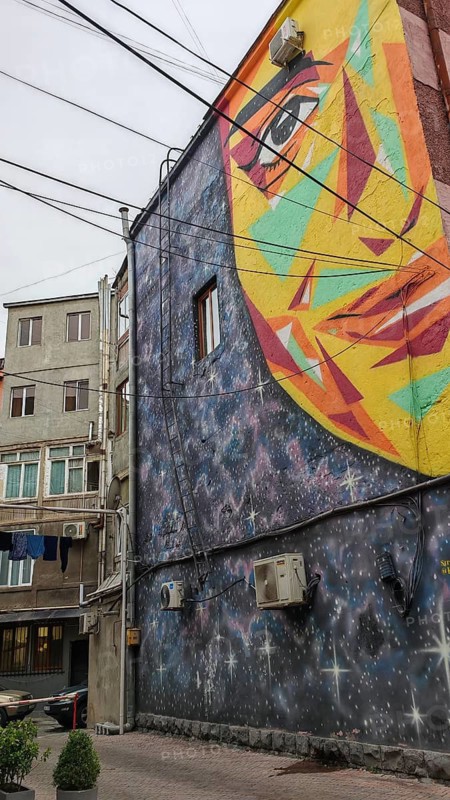 Colourful wall painting with face image on an urban building, Yerevan, Armenia