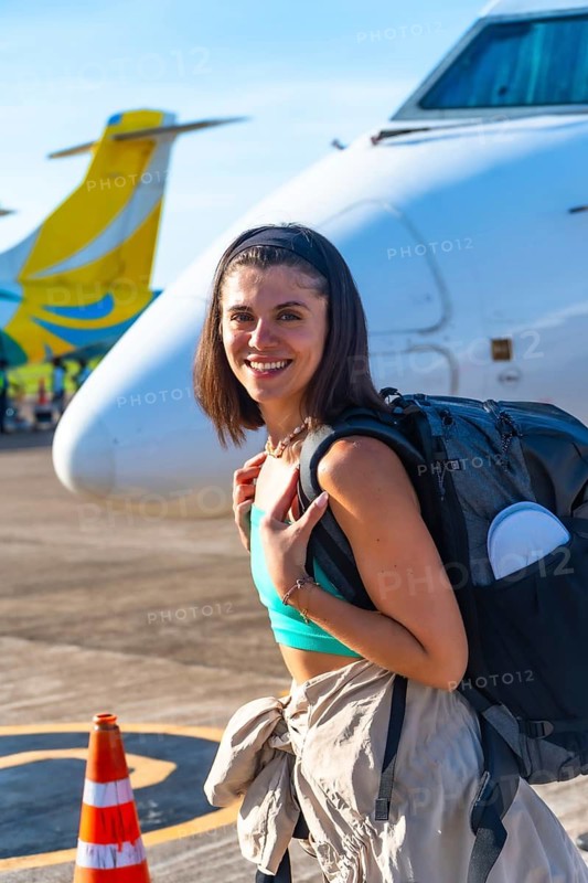 Young woman tourist is arriving at the airport on coron island, ready to start her philippines vacation