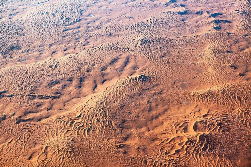Homogeneous desert surface with wave-like structures extending over a large area, The dunes of the Endless Sahara from the air in Algeria