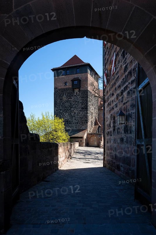 View through the archway to the pentagon tower of the Kaiserburg in the old town of Nuremberg, Middle Franconia, Franconia, Bavaria, Germany