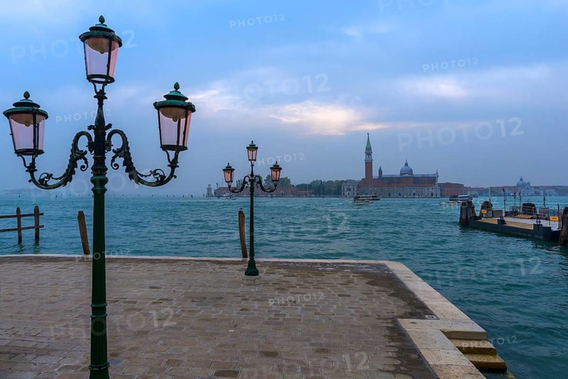 View of the island of San Giorgio Maggiore, with historic three-armed lanterns in front, Venice, Veneto, Italy