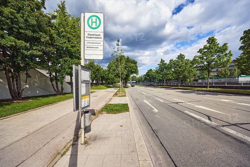 Bus stop Olympiapark Eissportstadion, 173 Feldmoching Bf, N76 Dülferstraße, bus stop sign, public transport, street, sidewalk, lanes, road markings direction arrows, trees, meadow, blue sky, white and dark gray cumulus clouds, Petuelring, Munich, state capital, district-free city, Bavaria, Germany