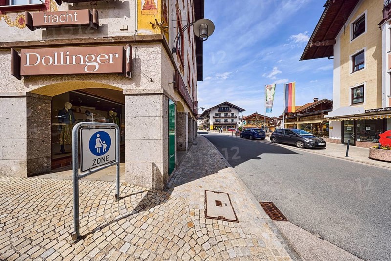 Dollinger fashion, sports and traditional costume, advertising sign, fashion shop, shops, access to the pedestrian zone, commercial buildings, arcades, façade, general architecture, alpine buildings, parking strips with cars, blue sky, cumulus clouds, cirrus clouds, confluence of Kirchberggasse with main alleyway, Ruhpolding, district of Traunstein, Bavaria, Germany