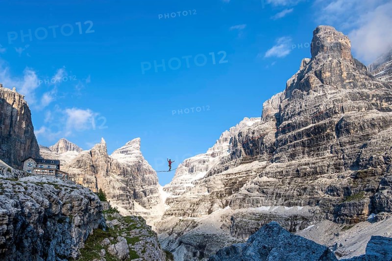 Slackliner in the mountains, mountain peaks of the Brenta Mountains, at Refugio Francis Fox Tuckett, Brenta, Brenta-Adamello Natural Park, Trentino, Italy