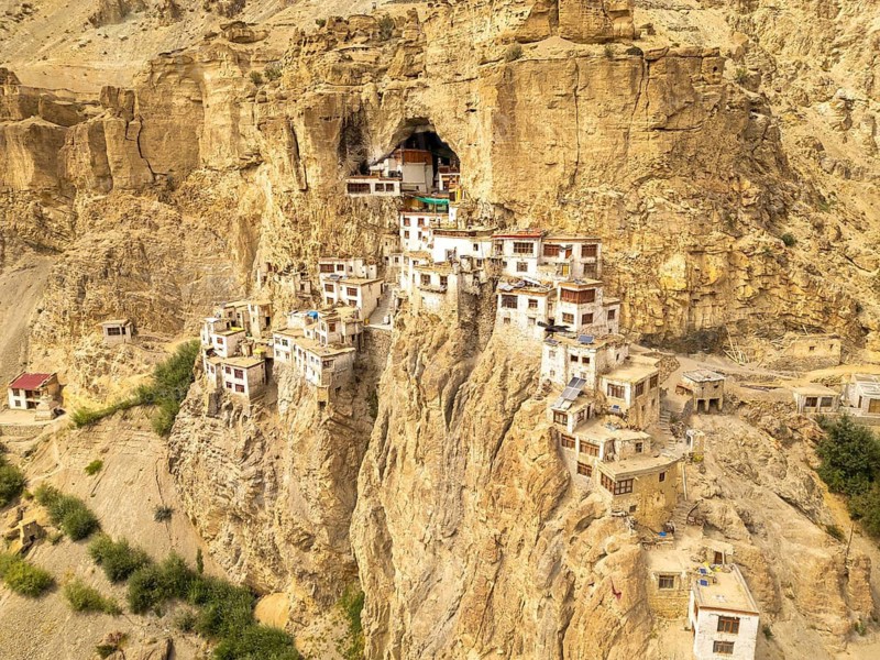 Phugtal Monastery in Ladakh, India, sits uniquely perched on rugged cliffs of the Himalayan region. This remote Buddhist sanctuary offers breathtaking views of Zanskar Valley