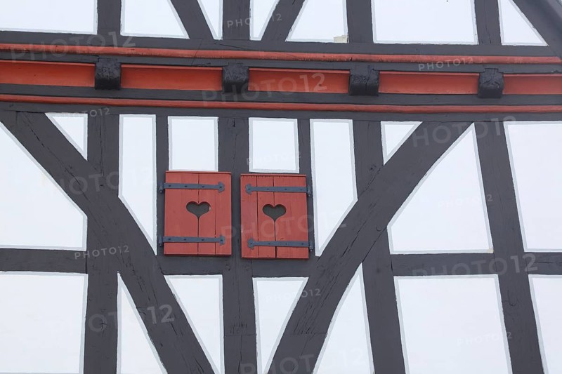 Heart-shaped decoration of shutters with two hearts, half-timbered house, brown wooden beams, detail, town hall, Schotten, Hesse, Germany