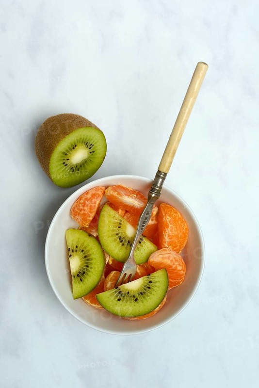 Clementine pieces and kiwi slices in peel