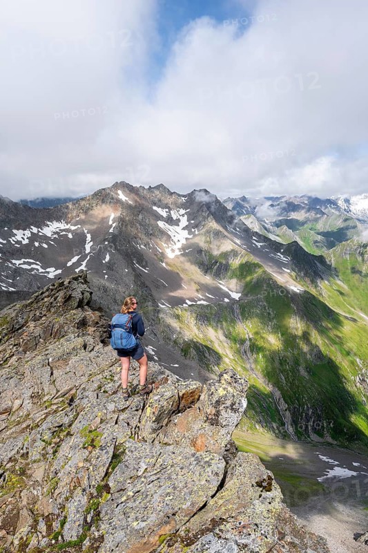Mountaineer on a steep rocky ridge, on the summit of the Lasörling, view of the mountain panorama of the Venediger Group, Lasörling Group, Hohe Tauern National Park, East Tyrol, Tyrol, Austria