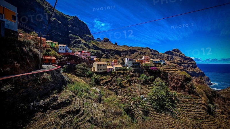 Panoramic view, small settlement, colorful village, nestled in raw, dramatic mountains under blue skies, spectacular hiking, natural heritage, cultural heritage, terraces in Fontainhas, Santo Antao, Cabo Verde, Cape Verde, Cape Verde, Cape Verde