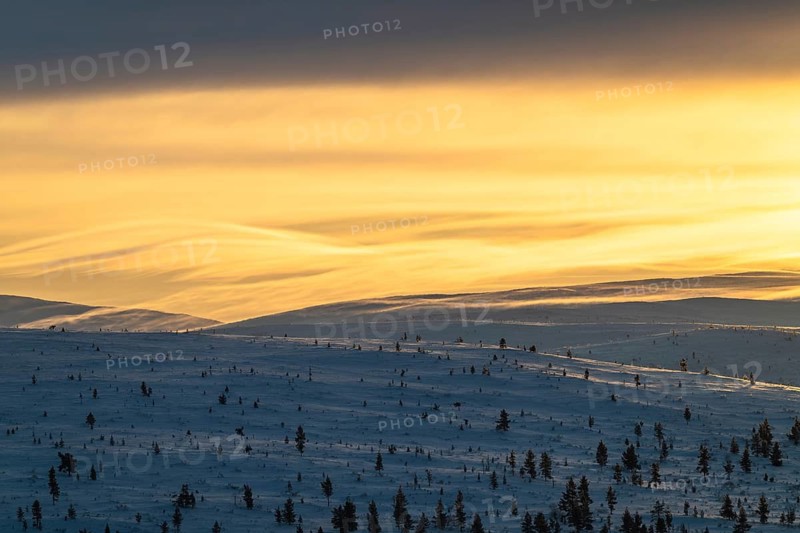 Lighting over snow-covered mountain ranges, Urho Kekkonen National Park, Lapland, Finland, January 2025