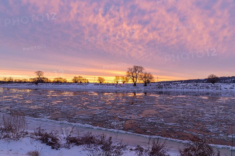 Cold winter morning on the Elbe with floating ice floes, snow and dawn at sunrise, Kötzschenbroda, Radebeul, Saxony, Germany
