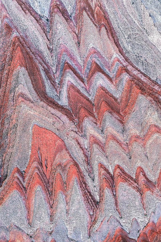 Stunning aerial image showcasing the intricate, colorful rock formations near the San Juan River in Utah. The patterns reflect geological history and erosion