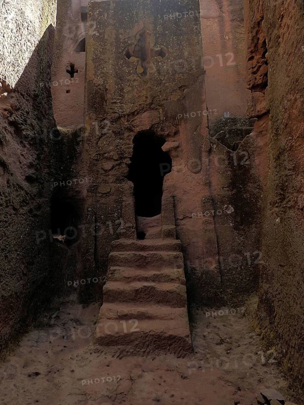 Entrance to a rock church with sandstone-colored steps and rough stone structure, UNESCO World Heritage Site, Lalibela rock church, Ethiopia