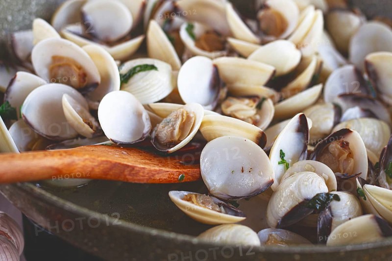 Cooking, vongole clams, in a pan with spices and white wine, top view, no people