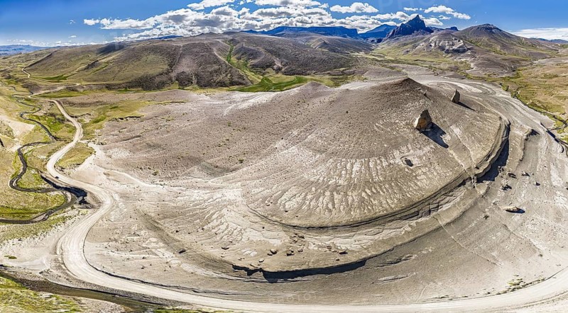 Road Ruta 41, gravel road, arid landscape, Mt. Cerro Boleadoras, volcano-shaped rock formation, Los Antiguos - Paso Roballo, aerial view, Argentina
