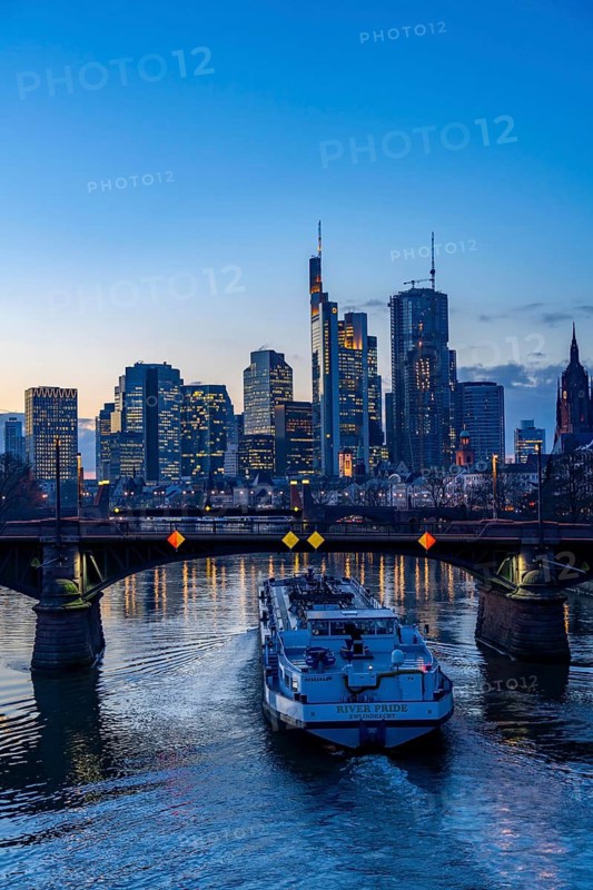 Skyline of the city centre of Frankfurt am Main, river Main, dusk, Ignatz-Bubis-Bridge, cargo ship, tanker, Hesse, Germany