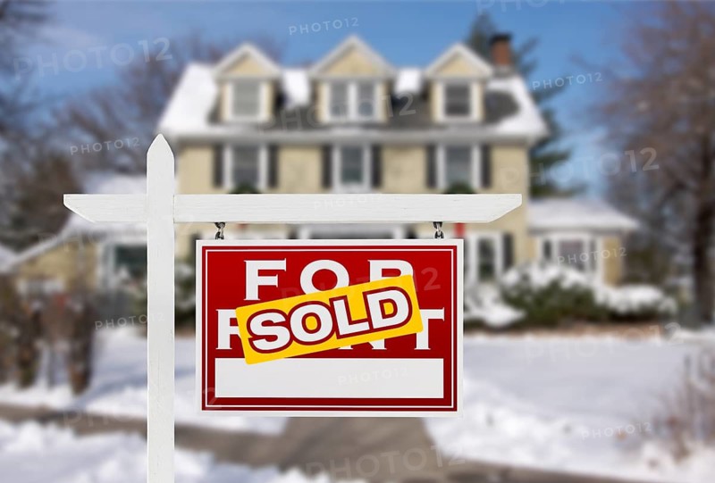 Sold Home For Sale Real Estate Sign in Front of New Snow Covered House