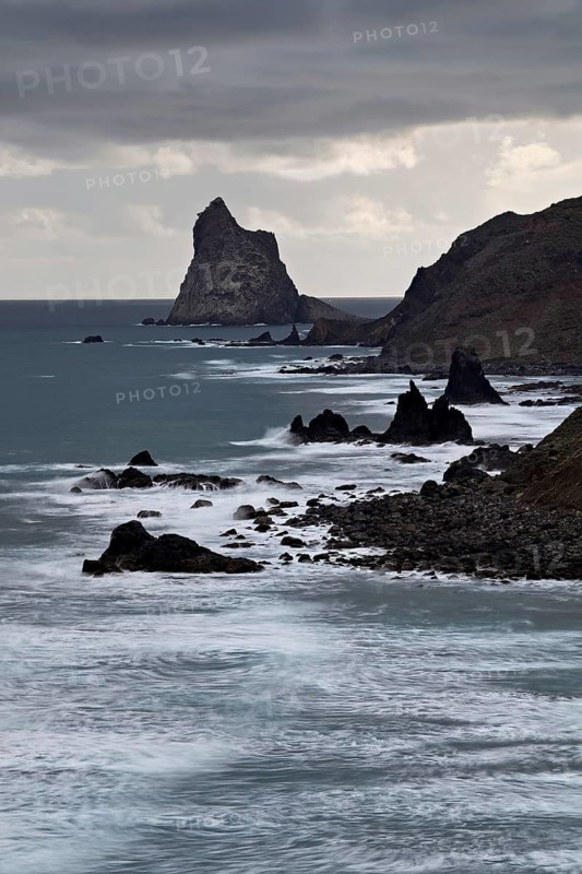 Beach of Playa de Benijo at high tide with the rock Roques de Anaga in the light of the rising sun, Tenerife, Canary Island, Spain