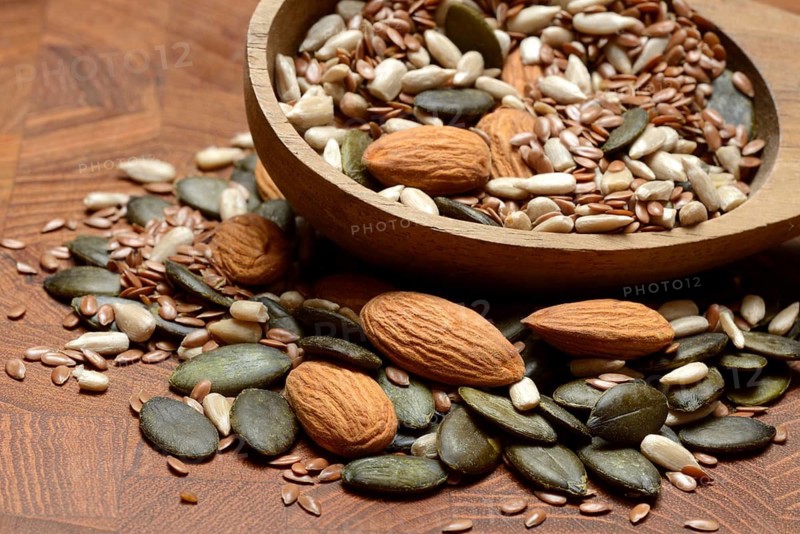 Kernels in ladle, kernel mix of almond kernels, sunflower seeds, linseeds and pumpkin seeds
