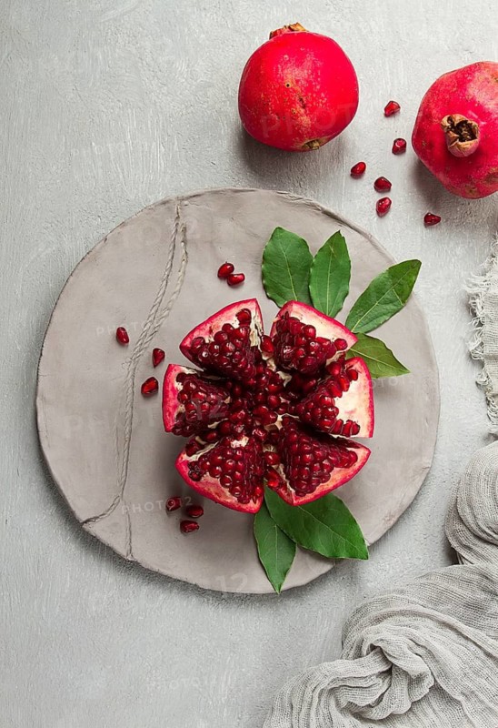Fresh, cut pomegranate fruit, on a gray background, food concept, top view, no people