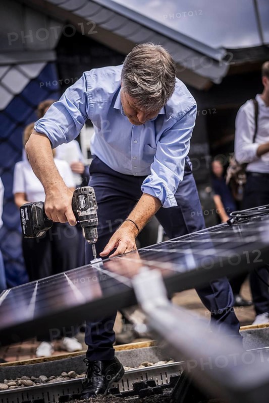 Federal Minister for Economic Affairs and Climate Protection Robert Habeck (Alliance 90/The Greens) on a summer tour of Germany. Here in Bochum, 10 July 2024, visiting a roofer with solar roof elements Photographed on behalf of the BMWK