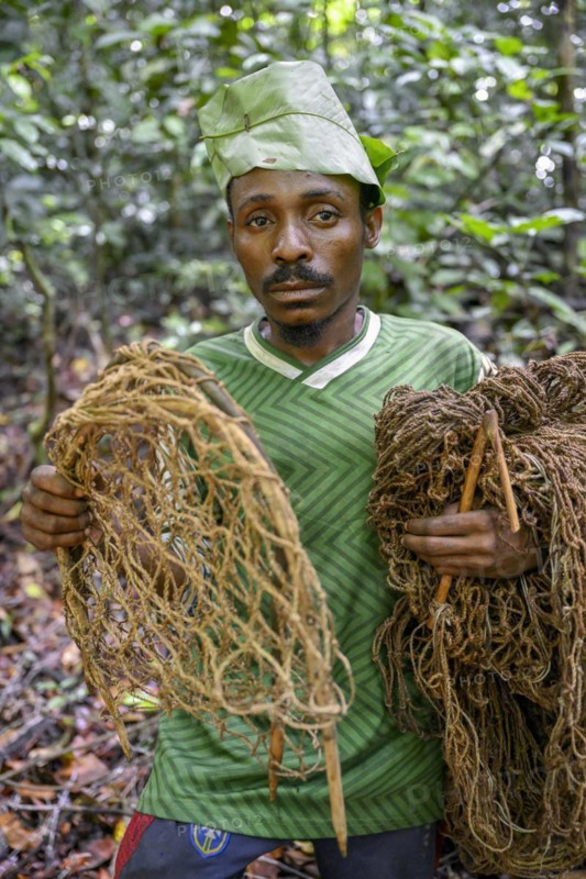 Pygmy of the Baka or BaAka people with his traps and hunting nets in the forest, Dzanga-Sangha Special Dense Forest Reserve, Sangha-Mbaéré Prefecture, Central African Republic