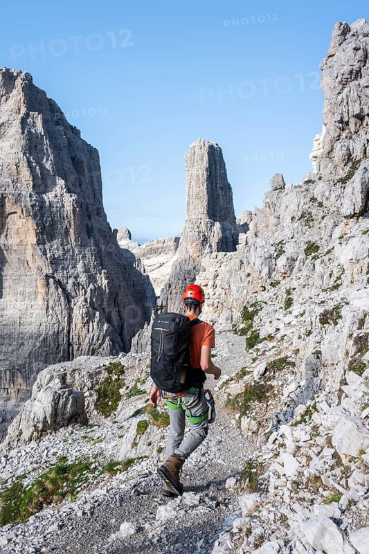 Climbers on a rock band, Bocchette Centrale band trail, via ferrata in the Brenta Mountains, Brenta-Adamello Natural Park, Trentino, Italy