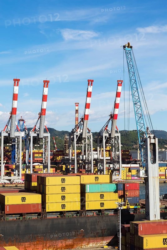 High angle view of stacked MSC, TEX and NileDutch metal box shipping containers loaded onto MSC Renaissance III cargo ship in La Spezia cargo Port, Italy