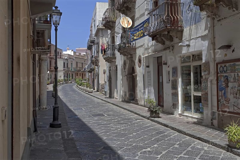 A quiet, paved street in an old town with old houses and balconies, Lipari Town Lipari Islands Sicily Italy
