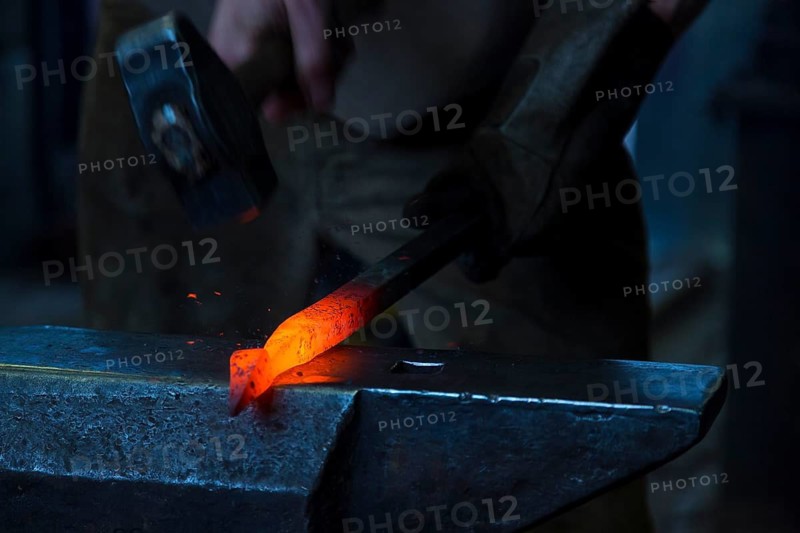 A blacksmith forging, working at the Ehnert forge in Dresden-Bühlau, Saxony, Germany
