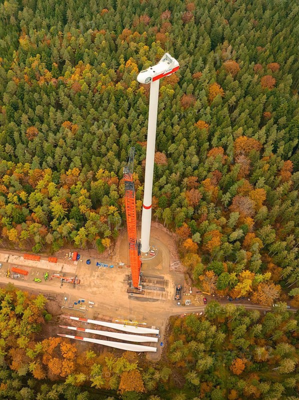 Overview of a wind turbine in the middle of an autumn-coloured forest from above, wind farm construction site, Grömbach, Black Forest, Germany