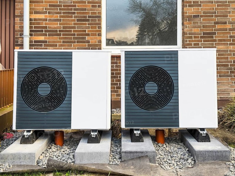 2 heat pumps are installed on an apartment block in a front garden, Hilden, Germany