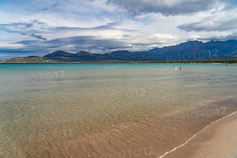The beach and mountains at Calvi Bay, Balagne, Corsica, France