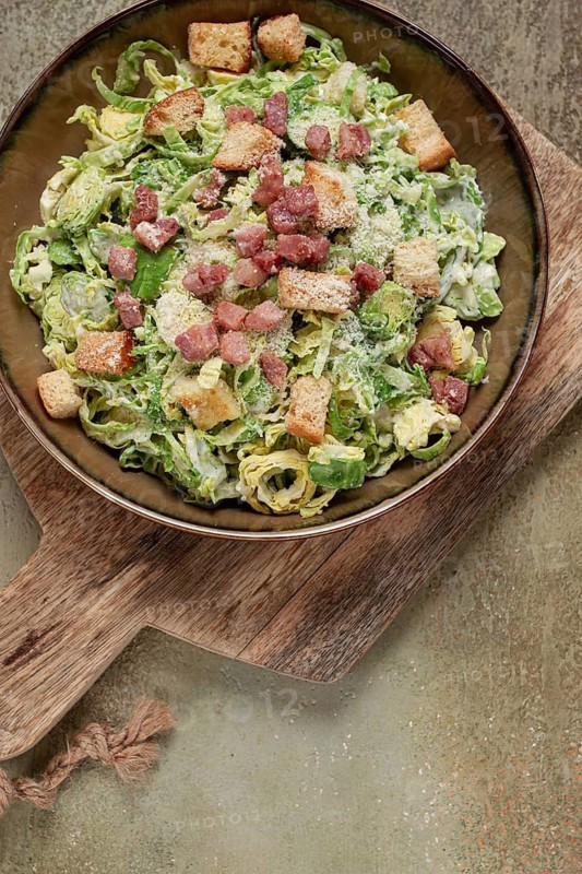 Brussels sprouts Caesar salad, with bacon and croutons, healthy food, homemade, no people